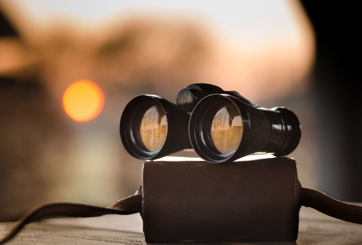 binoculars on a case at sunset